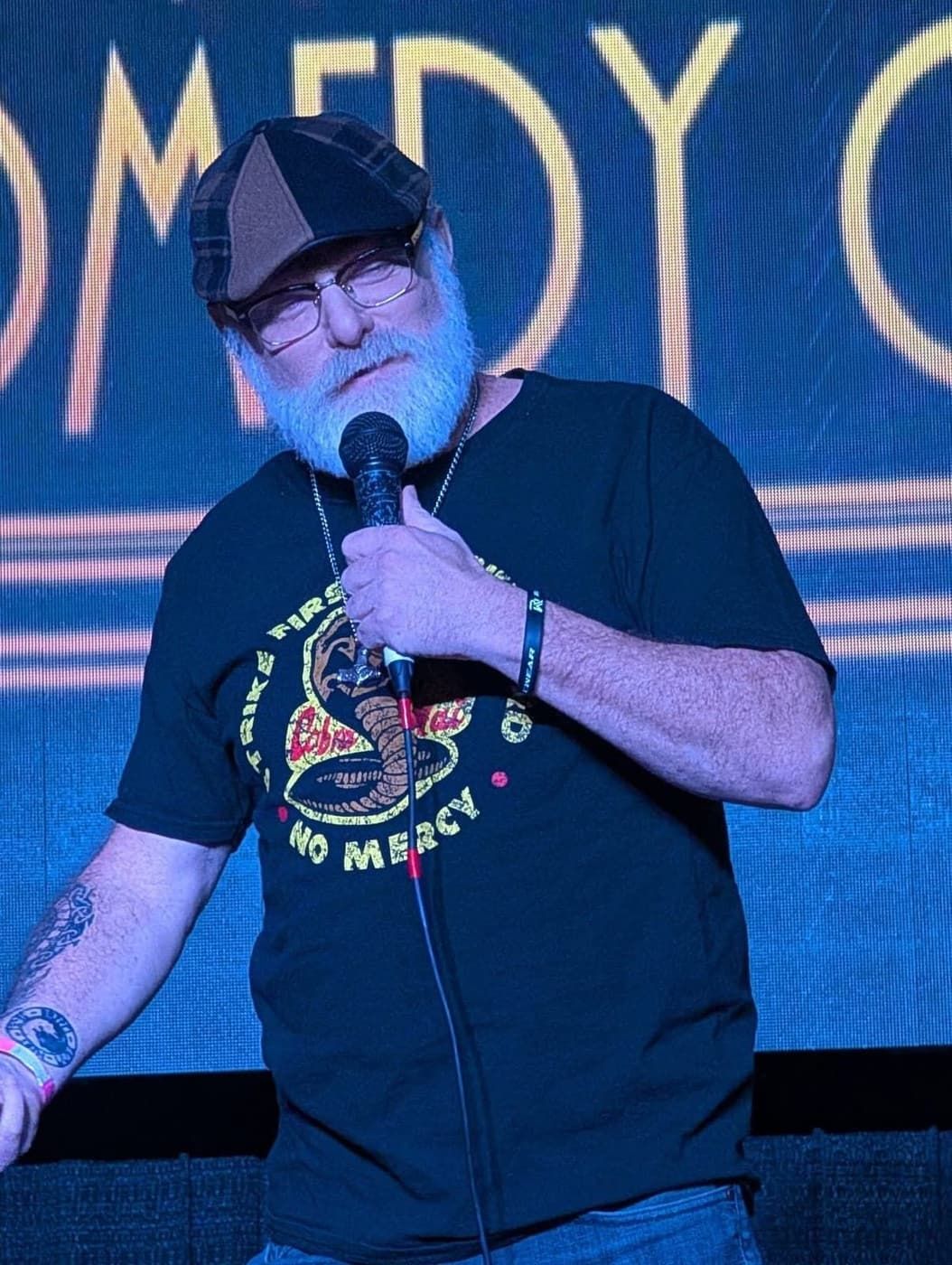 Uncle Danny performing in a Cobra Kai shirt